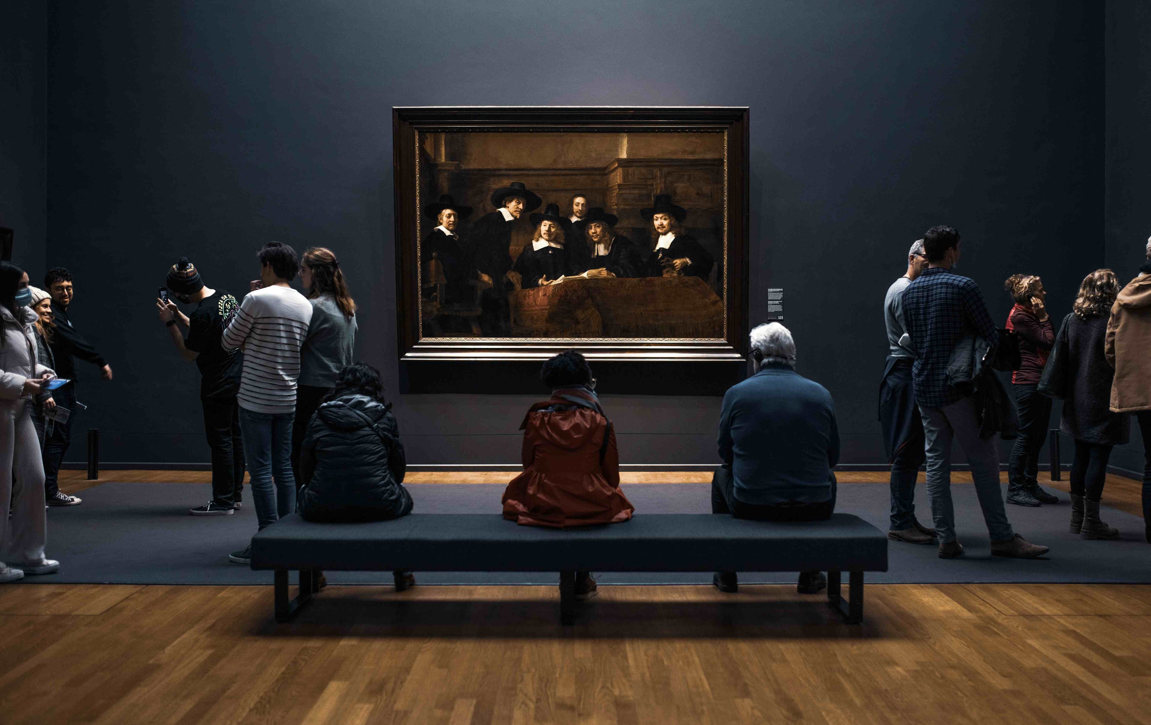people-sit-and-look-at-art-in-museum