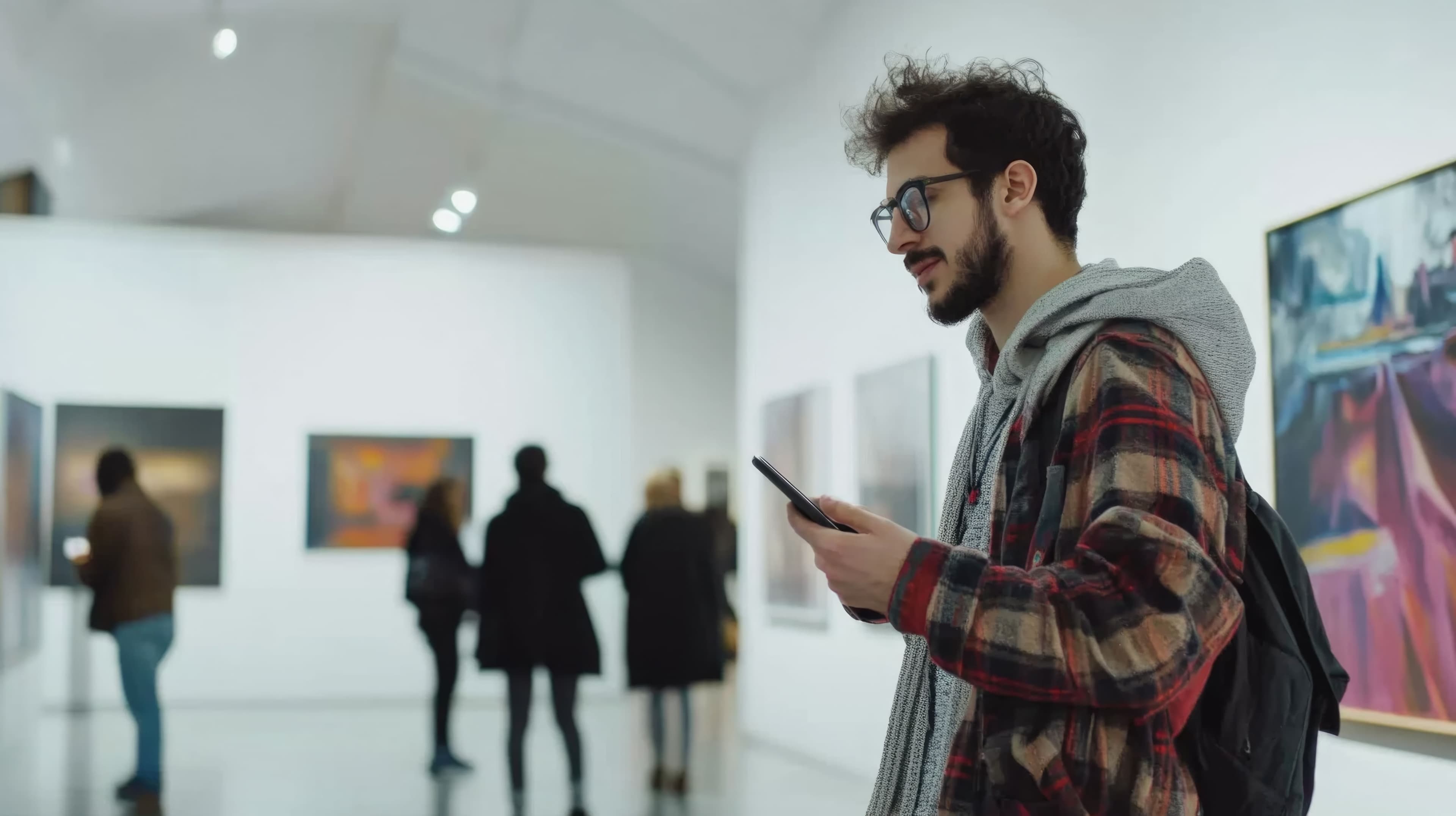 Man-looks-at-phone-in-gallery