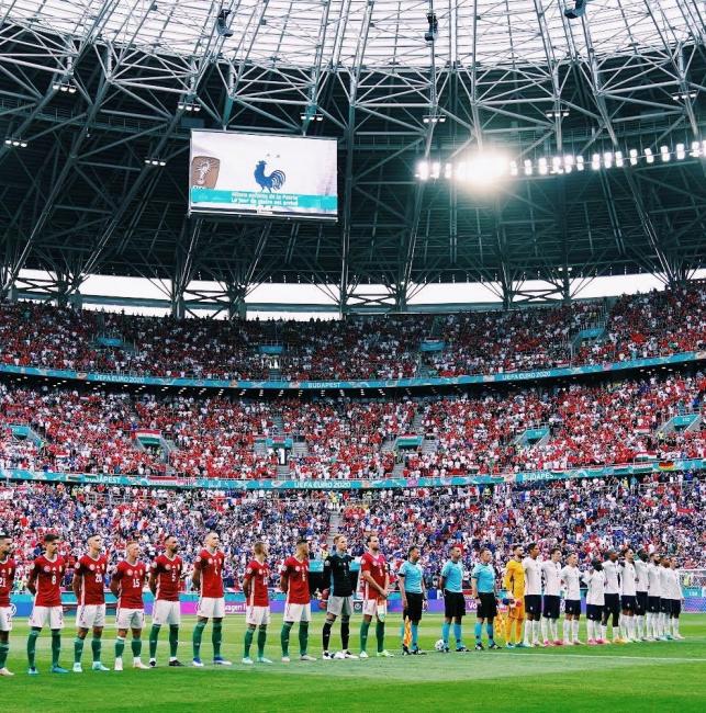 Football teams lined up for national anthems